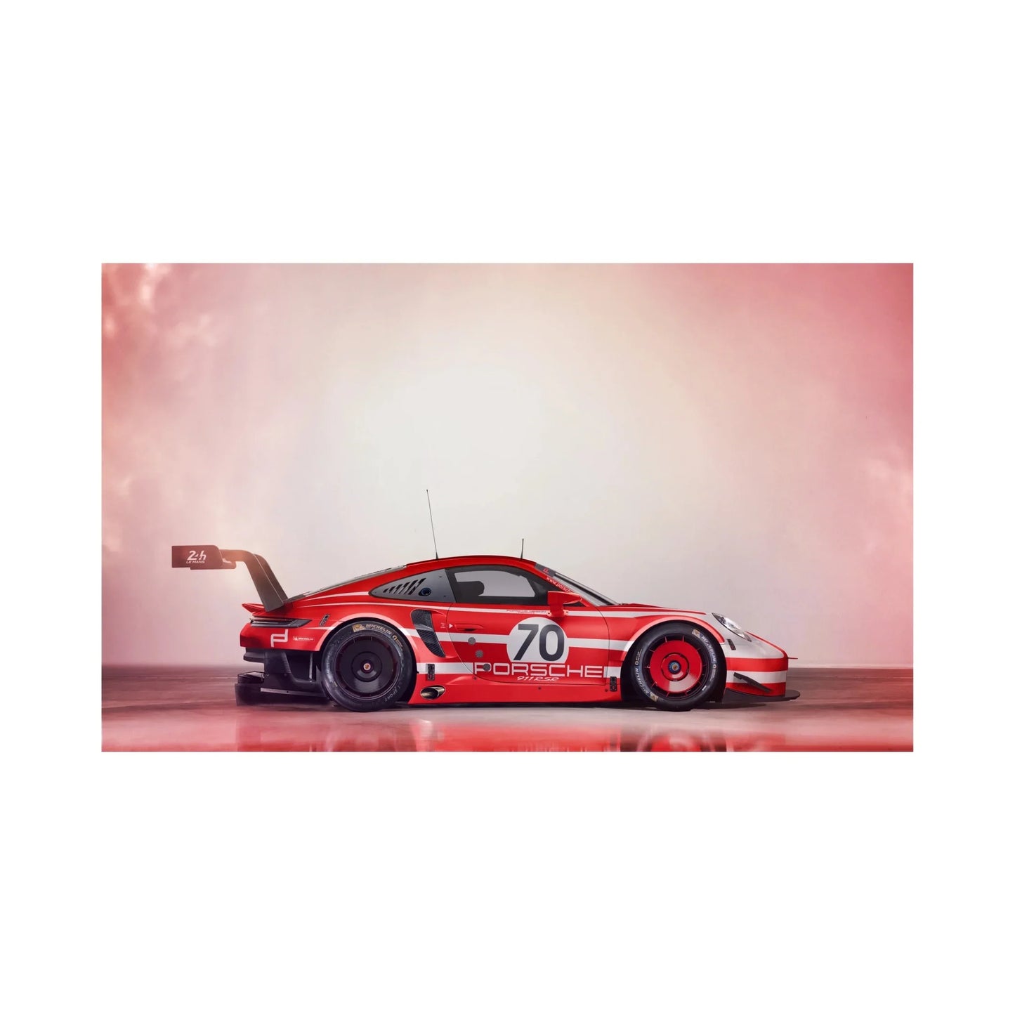 Red and white Porsche 911 RSR race car number 70 with large rear wing on reflective surface
