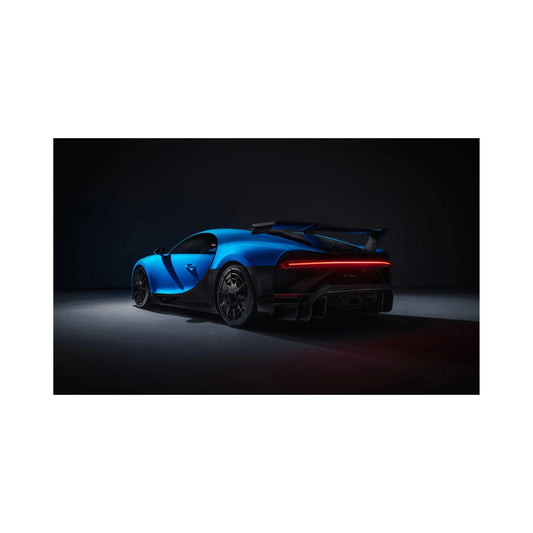 Blue and black Bugatti Chiron sports car rear view with large spoiler in dark studio