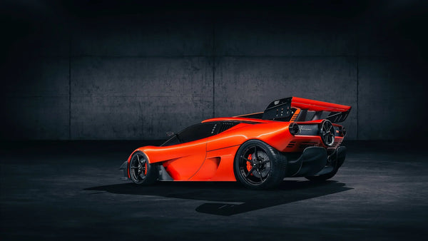 Sleek red Gordon Murray Automotive T.50s Niki Lauda supercar in dark industrial setting