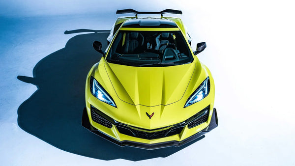 Yellow 2023 Chevrolet Corvette Z06 sports car with Z07 performance package and carbon fiber wing