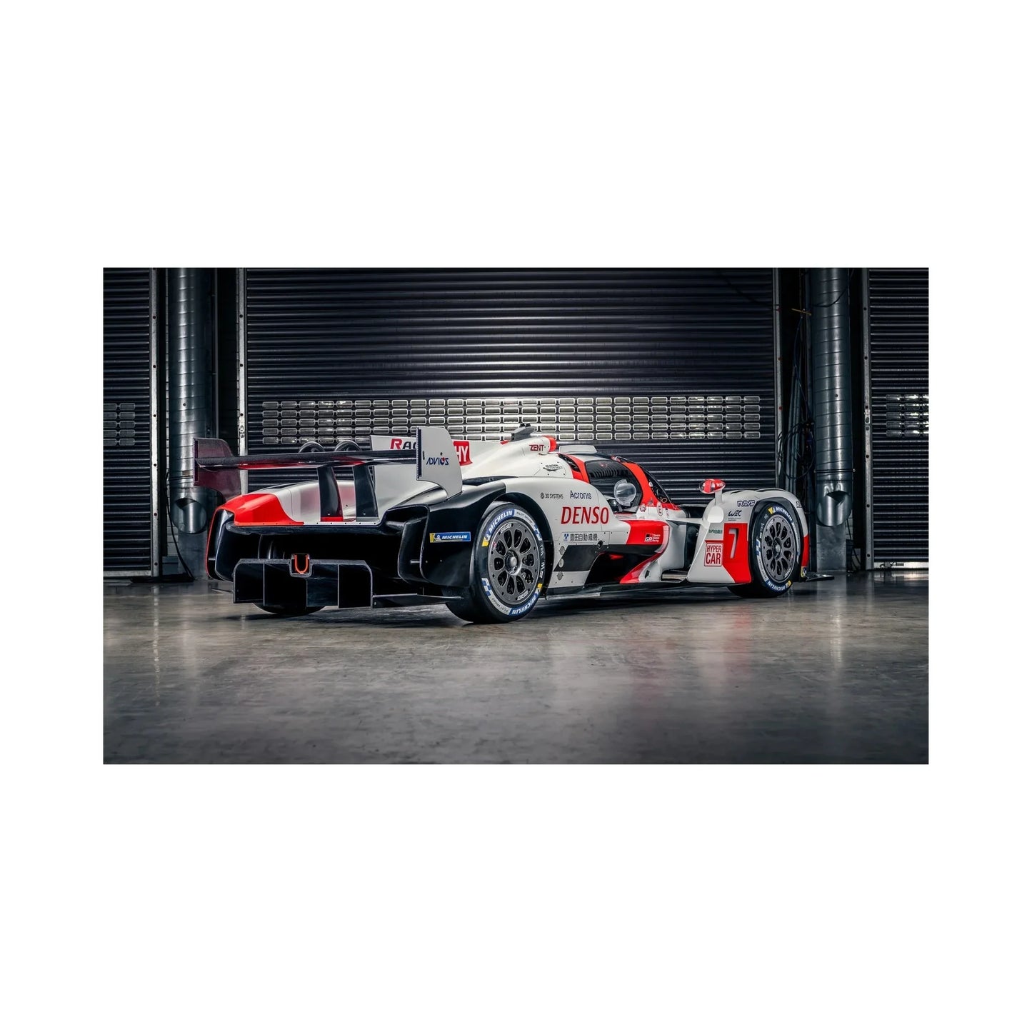 Toyota Gazoo Racing white red black Hypercar race car in garage with Michelin tires