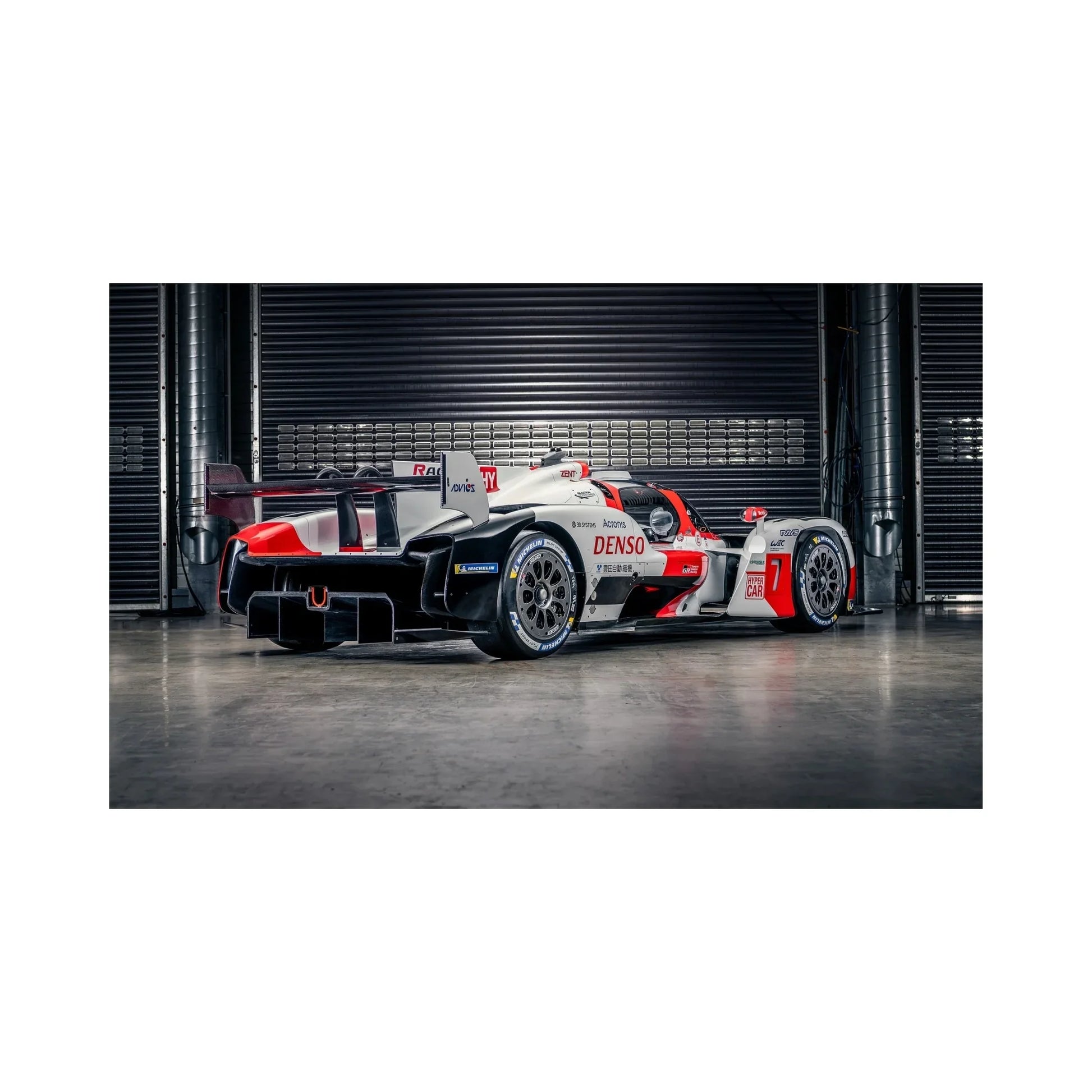 Toyota Gazoo Racing white red black Hypercar race car in garage with Michelin tires