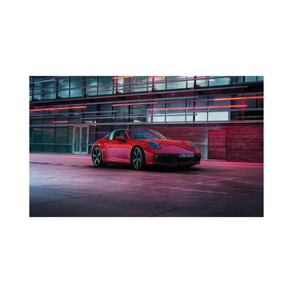 Red Porsche 911 Targa parked in front of modern glass building with red neon lights