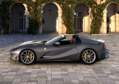 Grey Ferrari 812 GTS 2019 convertible sports car parked on stone pavement with ivy-covered arches background